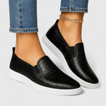 Sorte slip-on sneakers med præget overflade og hvid flad sål