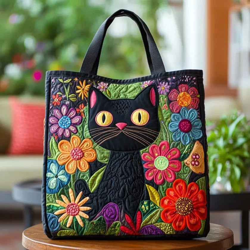 Quiltet mulepose med blomstermotiv og lange hanke