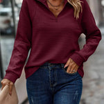 Kvinde i lyserød ribstrikket sweater med kort lynlås og rullekrave